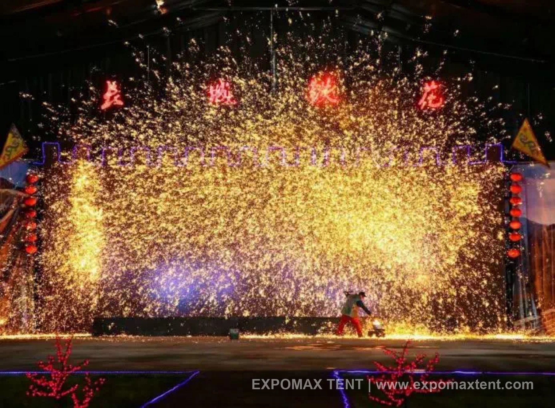 Live spark performance inside a tent venue