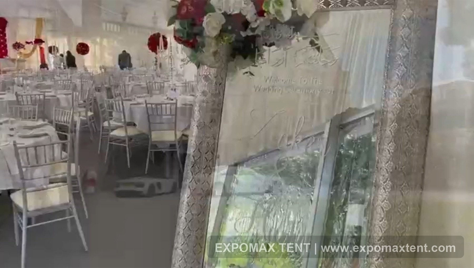 Wedding welcome detail and banquet setup inside hotel tent