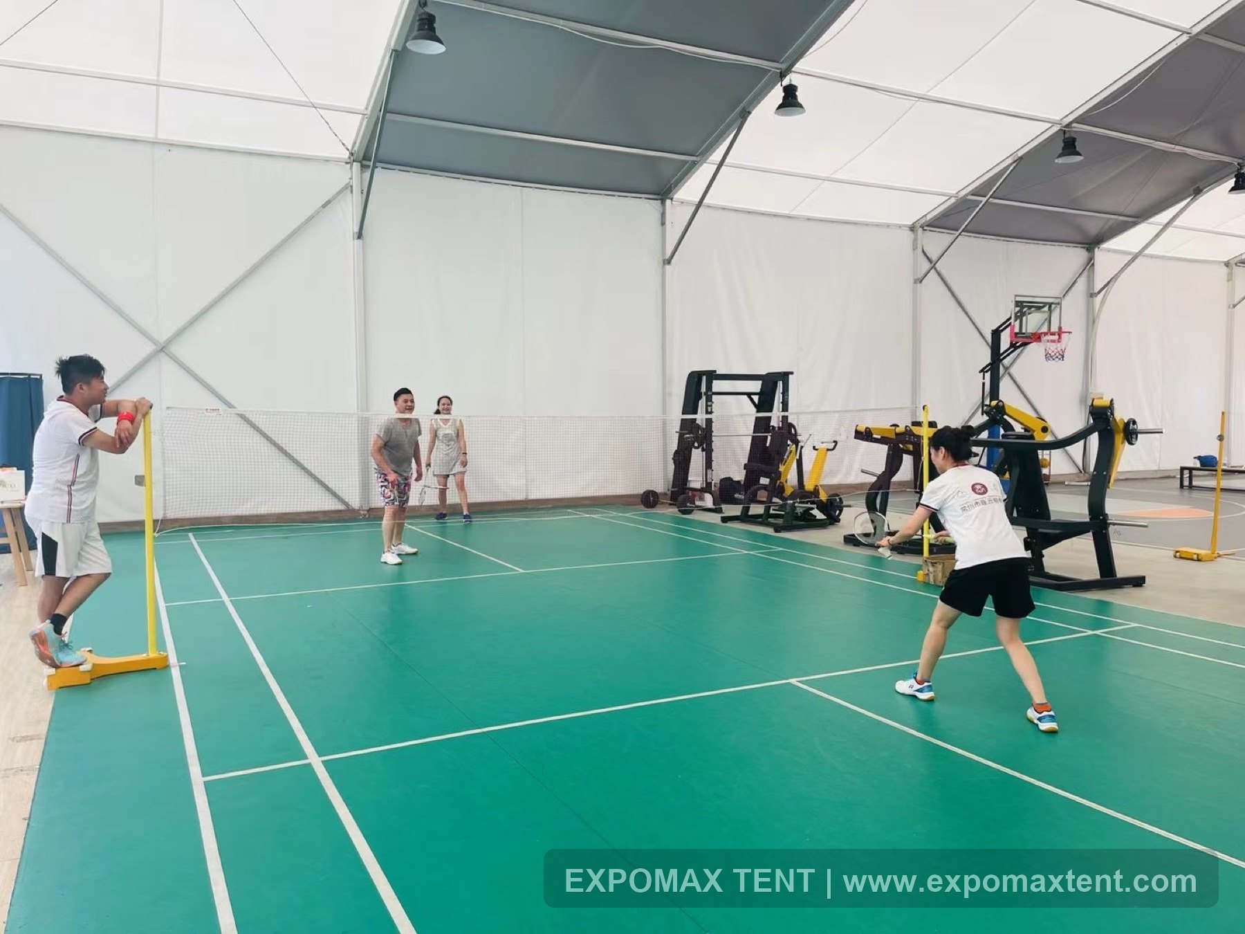 Badminton court and fitness equipment inside sports tent