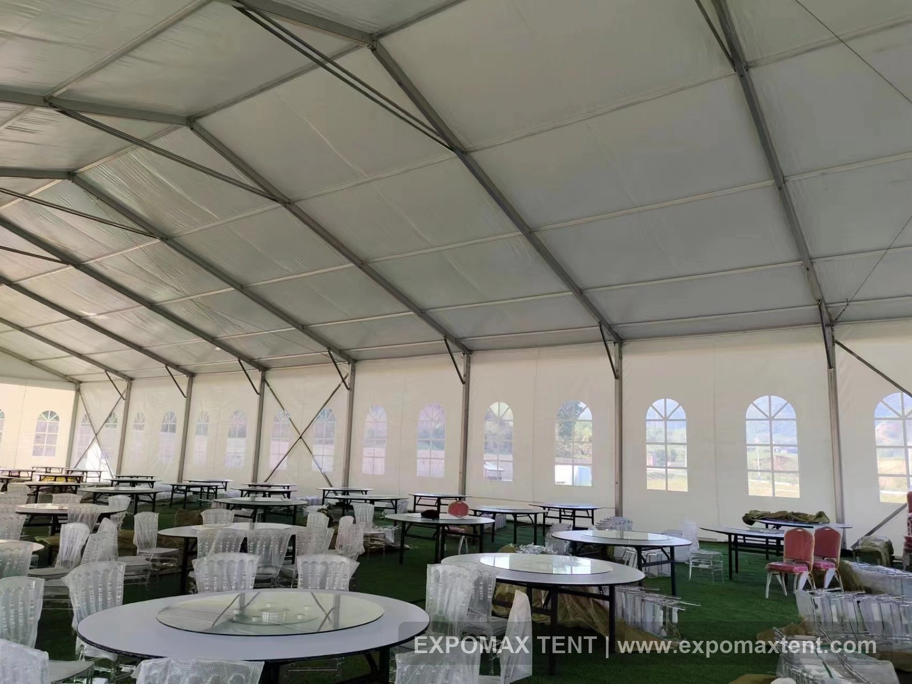 Arched window wall and banquet seating inside Chengde wedding tent