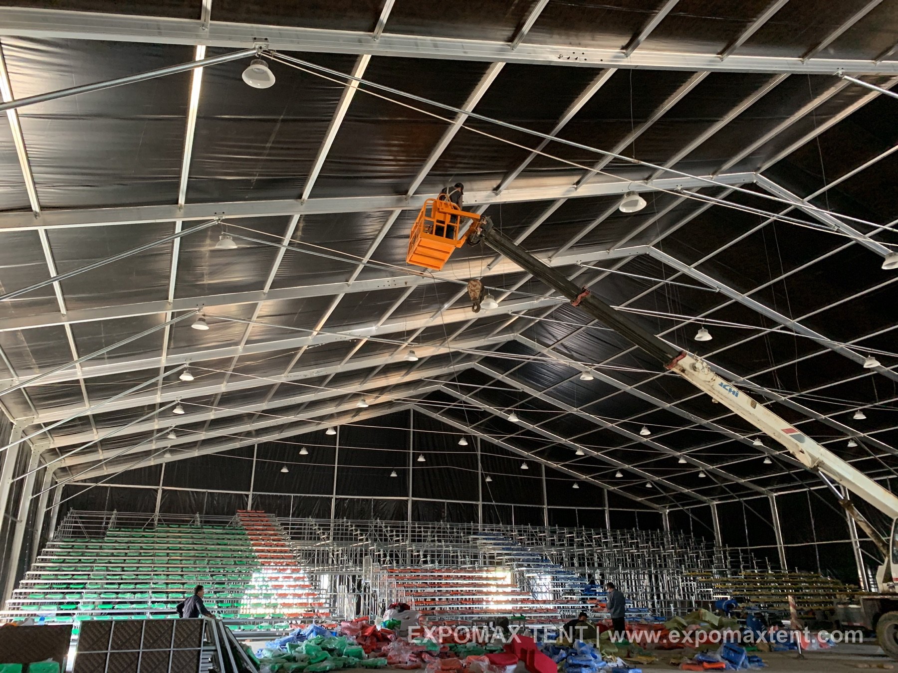 Large performance tent under construction with seating