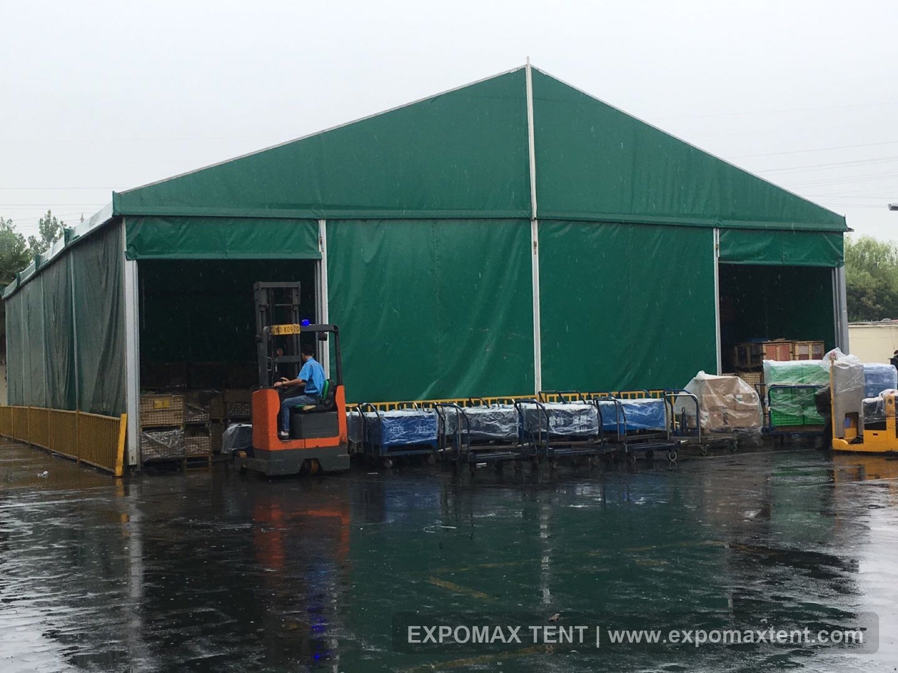 Green custom temporary industrial tent with forklift access