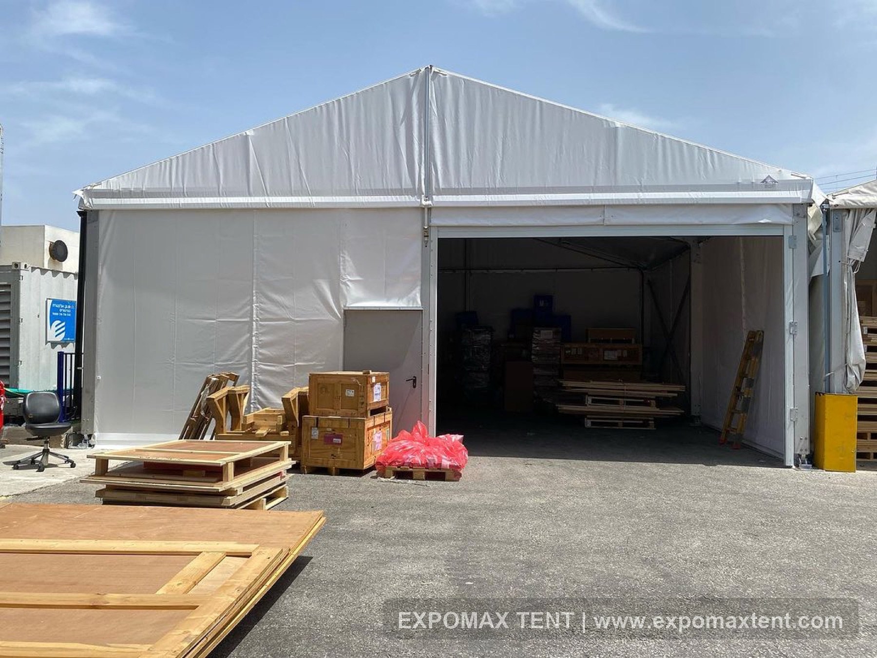 Warehouse tent with loading door and stored materials