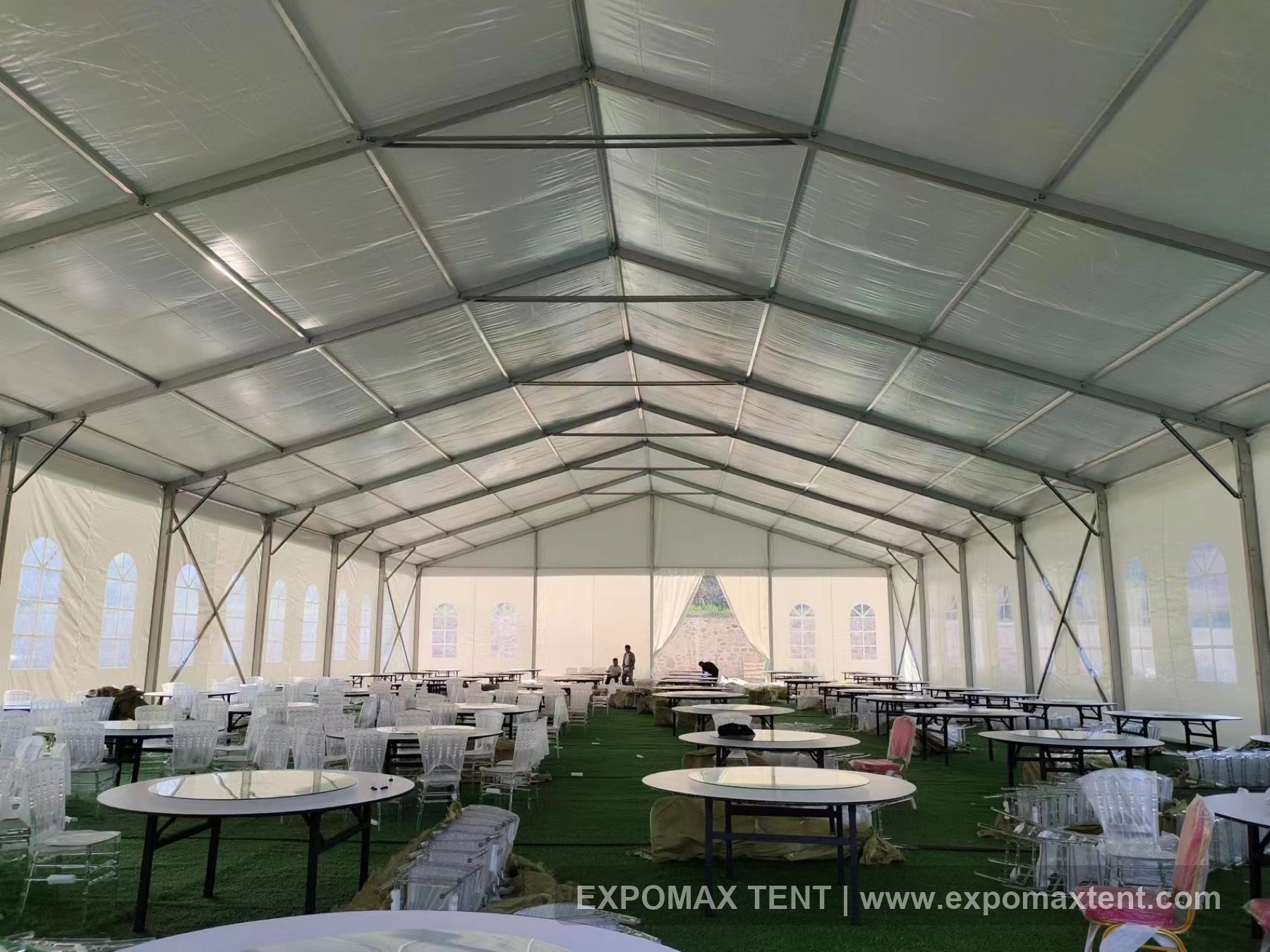 Banquet tables arranged inside a wedding tent